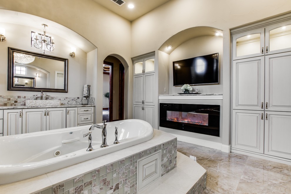 Huge transitional master beige tile and mosaic tile marble floor bathroom photo in Austin with a vessel sink, furniture-like cabinets, white cabinets, granite countertops and a two-piece toilet