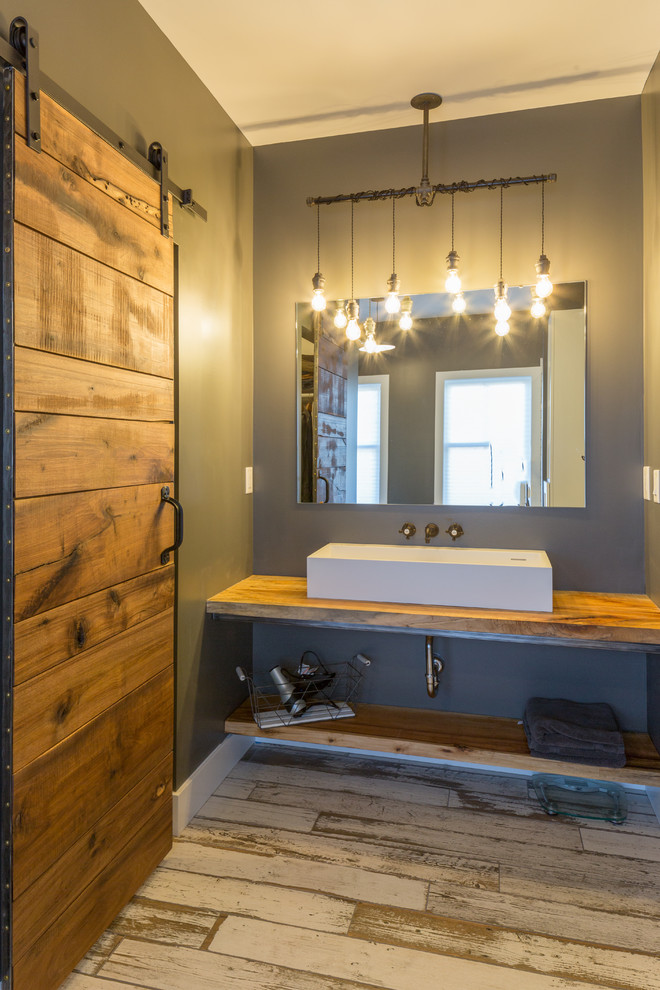Inspiration for a mid-sized cottage master white tile and subway tile dark wood floor and brown floor bathroom remodel in Detroit with open cabinets, wood countertops, medium tone wood cabinets, brown countertops, a two-piece toilet, gray walls, a wall-mount sink and a hinged shower door