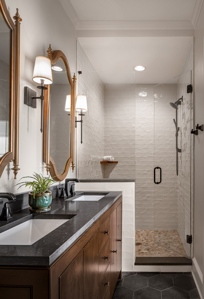 Example of a large transitional master white tile and subway tile ceramic tile and gray floor wet room design in Atlanta with furniture-like cabinets, dark wood cabinets, a one-piece toilet, beige walls, an undermount sink, quartz countertops, a hinged shower door and gray countertops