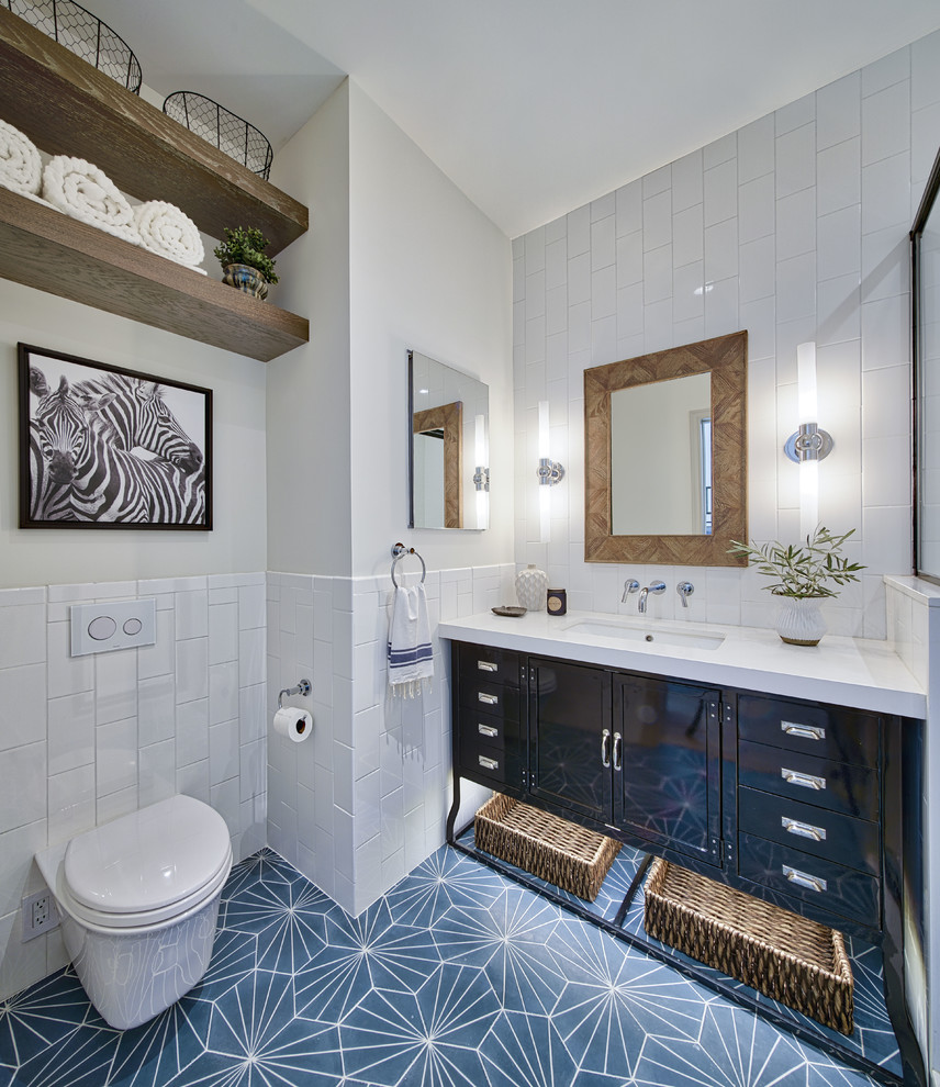 Mid-sized eclectic 3/4 white tile and ceramic tile cement tile floor and blue floor alcove shower photo in Las Vegas with furniture-like cabinets, black cabinets, a wall-mount toilet, white walls, an undermount sink, quartz countertops, a hinged shower door and white countertops