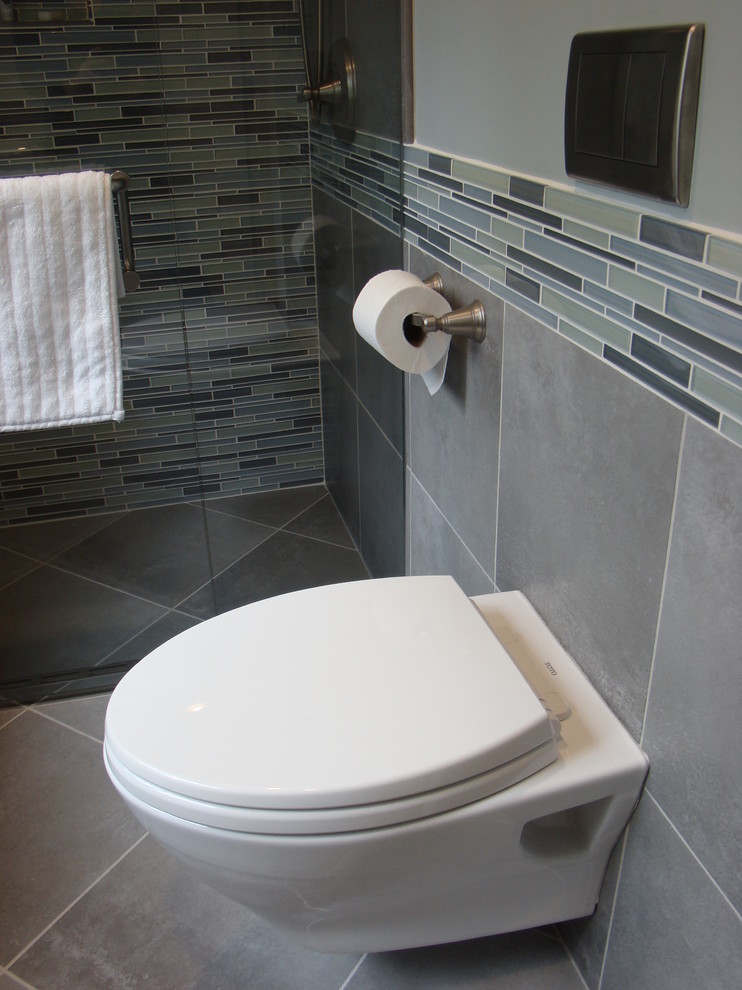 Inspiration for a small contemporary shower room bathroom in Portland Maine with a wall-mounted sink, a built-in shower, a wall mounted toilet, multi-coloured tiles, blue walls and porcelain flooring.