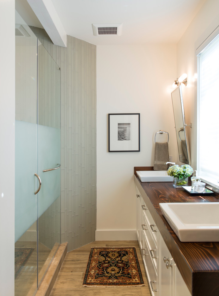 Mid-sized transitional 3/4 multicolored tile and glass tile porcelain tile alcove shower photo in DC Metro with a vessel sink, recessed-panel cabinets, white cabinets, wood countertops and beige walls