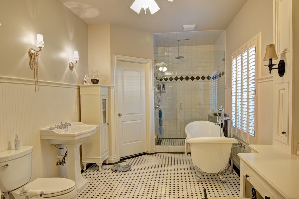 Photo of a traditional bathroom in Oklahoma City with a pedestal sink, freestanding cabinets, white cabinets, wooden worktops, a claw-foot bath, a double shower, a two-piece toilet, white tiles and ceramic tiles.