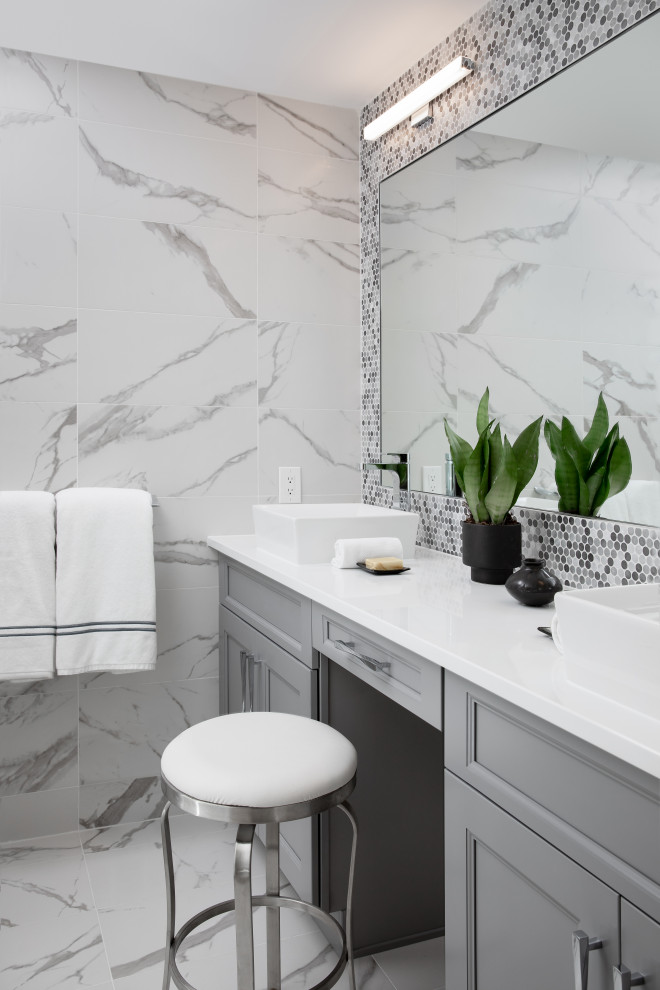 Example of a mid-sized trendy kids' white tile and porcelain tile porcelain tile, white floor and double-sink bathroom design in Newark with gray cabinets, a one-piece toilet, white walls, a vessel sink, quartz countertops, a hinged shower door, white countertops, shaker cabinets and a built-in vanity