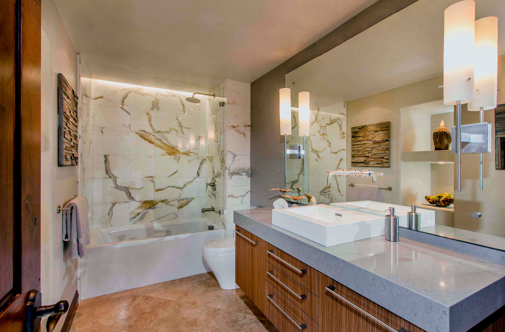 Mid-sized trendy multicolored tile and stone tile limestone floor bathroom photo in San Diego with flat-panel cabinets, medium tone wood cabinets, beige walls and quartz countertops
