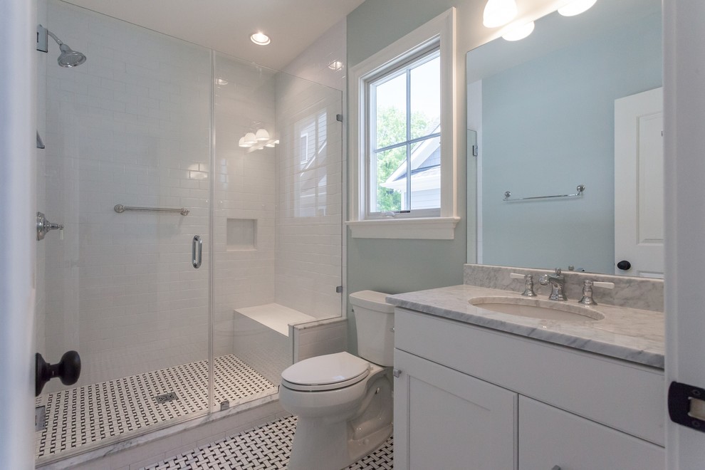 Photo of a traditional bathroom in DC Metro with recessed-panel cabinets, white cabinets, an alcove shower, a two-piece toilet, white tiles, metro tiles, green walls, a submerged sink, a hinged door and grey worktops.