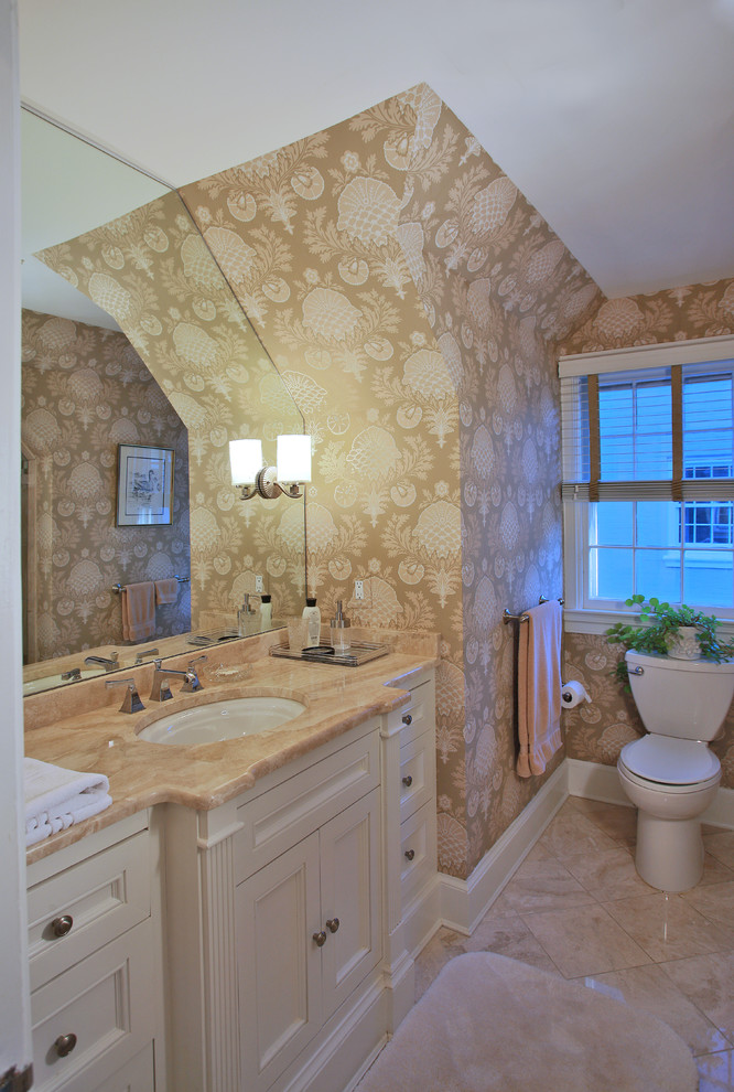 Foto på ett litet amerikanskt badrum med dusch, med ett undermonterad handfat, luckor med infälld panel, vita skåp, marmorbänkskiva, en toalettstol med hel cisternkåpa, beige kakel, keramikplattor, gröna väggar och marmorgolv