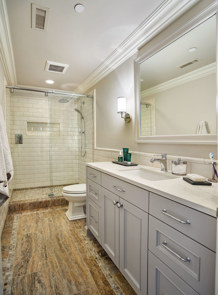 Alcove shower - large traditional kids' white tile and ceramic tile porcelain tile alcove shower idea in Portland with recessed-panel cabinets, gray cabinets, gray walls, an undermount sink and quartz countertops