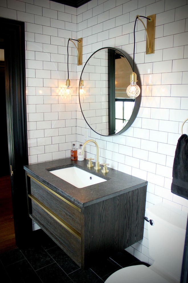 Example of a small trendy black tile and stone tile bathroom design in New York with flat-panel cabinets, dark wood cabinets, white walls and an undermount sink