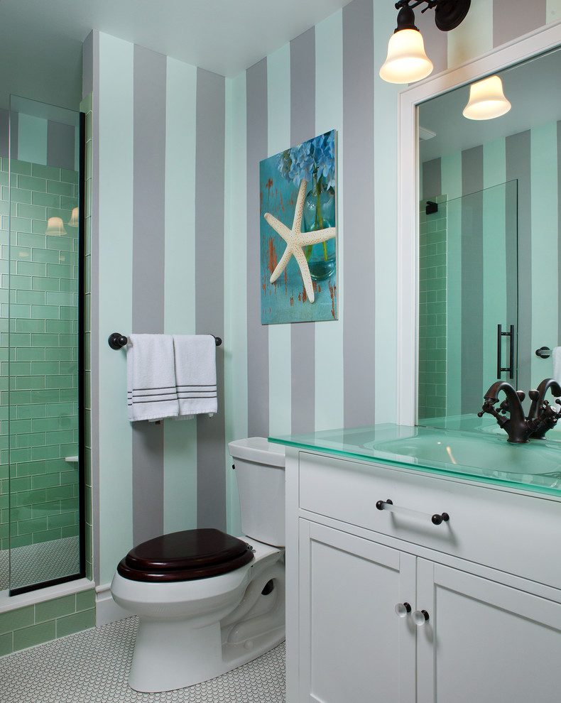 Mid-sized beach style 3/4 green tile and glass tile mosaic tile floor and white floor alcove shower photo in Portland Maine with beaded inset cabinets, white cabinets, a two-piece toilet, white walls, an integrated sink, glass countertops and a hinged shower door