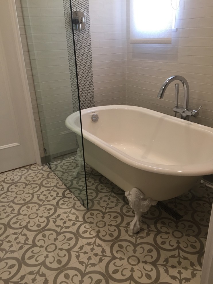 Inspiration for a medium sized mediterranean shower room bathroom in Los Angeles with freestanding cabinets, white cabinets, a claw-foot bath, a shower/bath combination, a one-piece toilet, grey tiles, metro tiles, grey walls, cement flooring, an integrated sink, tiled worktops, grey floors and an open shower.