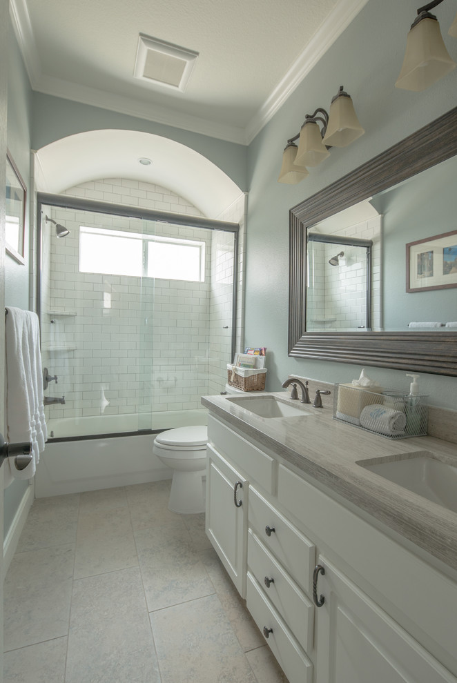 Bathroom - mid-sized traditional master white tile and subway tile porcelain tile bathroom idea in Houston with an undermount sink, flat-panel cabinets, white cabinets, limestone countertops and blue walls