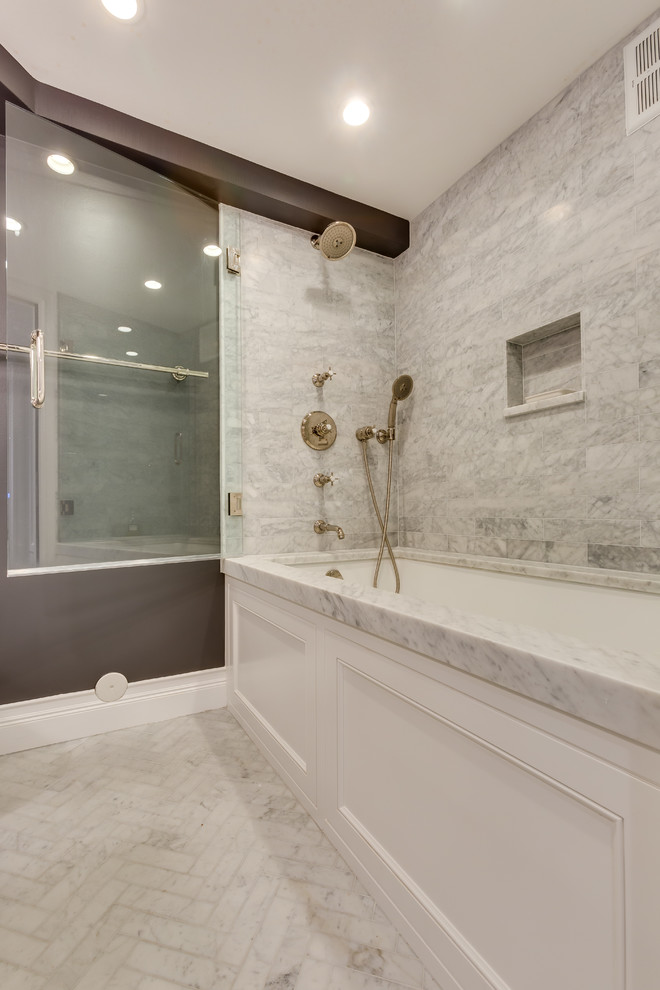 Design ideas for a small traditional bathroom in Chicago with recessed-panel cabinets, white cabinets, multi-coloured tiles, stone slabs, grey walls, marble flooring, a submerged sink, marble worktops, an alcove bath and a shower/bath combination.