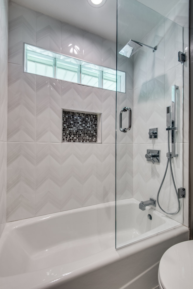 This is an example of a contemporary bathroom in Dallas with a shower/bath combination, beige tiles, glass tiles, porcelain flooring, quartz worktops, grey floors, a sliding door and white worktops.