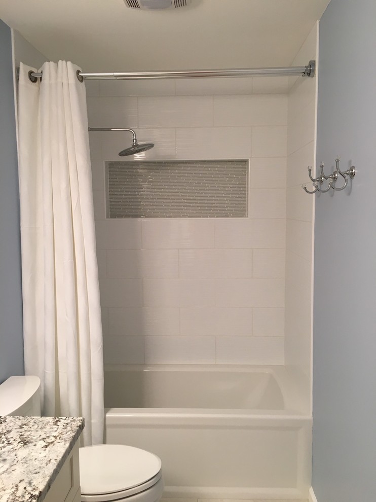 Example of a mid-sized transitional kids' white tile and porcelain tile ceramic tile and beige floor bathroom design in New York with a two-piece toilet, blue walls, shaker cabinets, white cabinets and an undermount sink