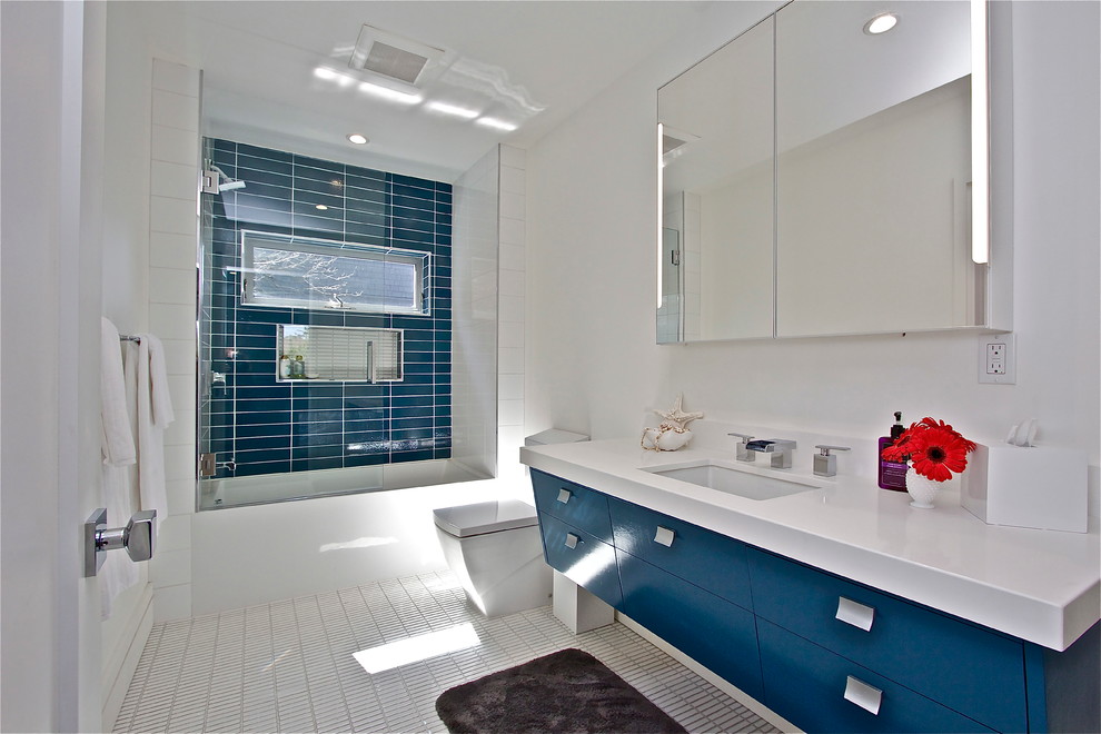 Inspiration for a mid-century modern blue tile and ceramic tile porcelain tile bathroom remodel in San Francisco with an undermount sink, blue cabinets, quartz countertops, a one-piece toilet and white walls