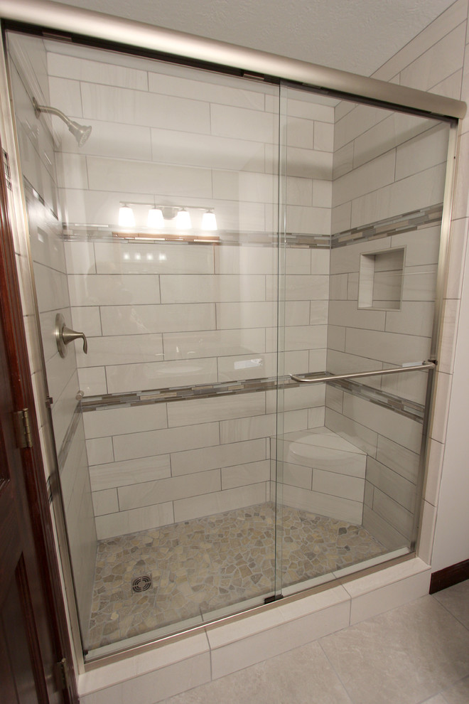 Photo of a small classic family bathroom in Cleveland with a submerged sink, dark wood cabinets, granite worktops, an alcove shower, beige tiles, beige walls and porcelain flooring.