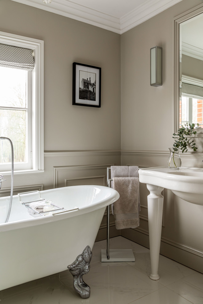Photo of a medium sized traditional family bathroom in Essex with white cabinets, a claw-foot bath, grey walls, marble flooring, white floors, white worktops, a single sink, a freestanding vanity unit and panelled walls.