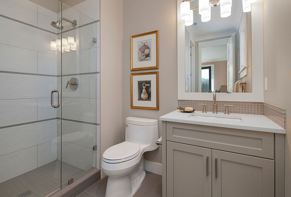 Photo of a contemporary bathroom in Seattle with porcelain flooring, a submerged sink, recessed-panel cabinets, grey cabinets, engineered stone worktops, an alcove shower, grey tiles, porcelain tiles and beige walls.