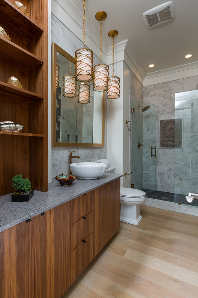 Large beach style ensuite bathroom in Miami with flat-panel cabinets, medium wood cabinets, marble worktops, an alcove shower, a one-piece toilet, multi-coloured walls and light hardwood flooring.