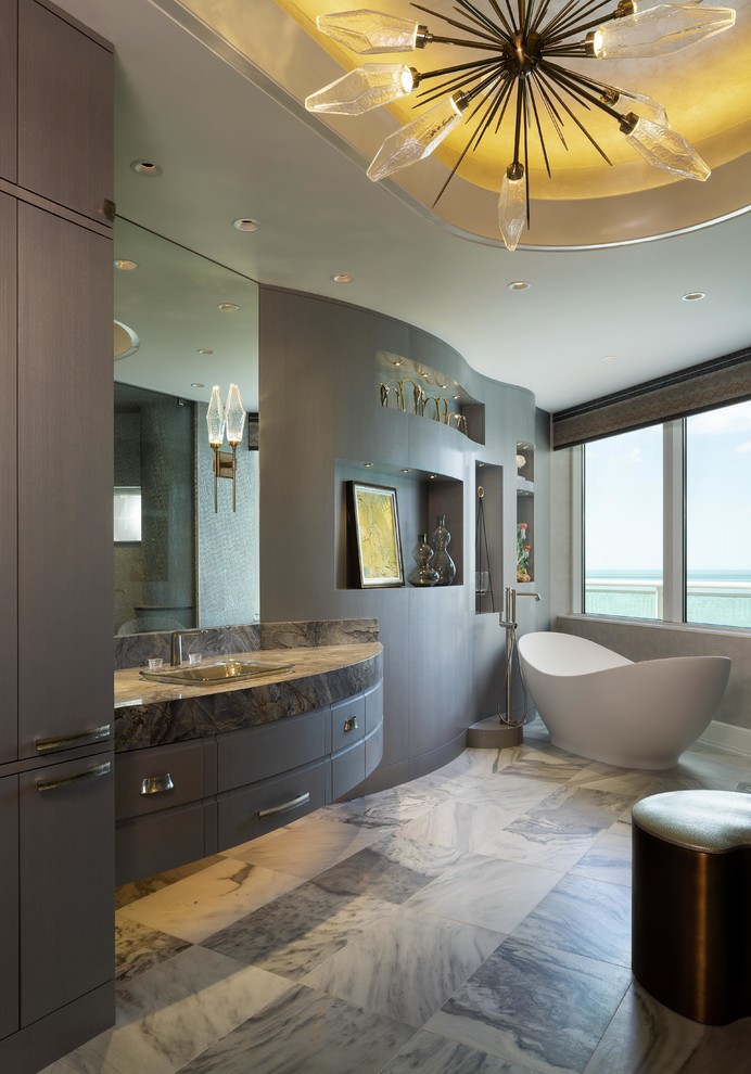 Design ideas for a large contemporary ensuite bathroom in Miami with flat-panel cabinets, grey cabinets, a freestanding bath, a corner shower, grey walls, marble flooring, a built-in sink, granite worktops, multi-coloured floors, a hinged door and multi-coloured worktops.