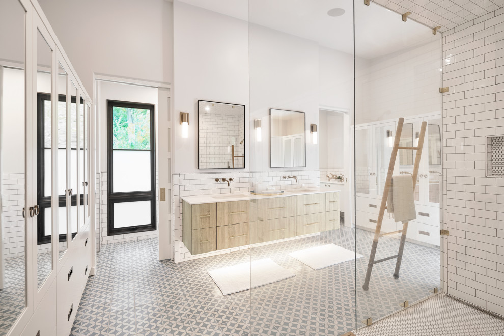 This is an example of an expansive contemporary master bathroom in Grand Rapids with a curbless shower, white tile, subway tile, white walls, ceramic floors, white floor, a hinged shower door and white benchtops.