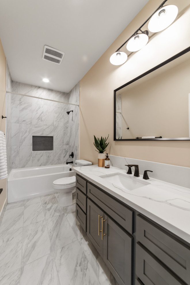 Photo of a medium sized traditional ensuite bathroom in Sacramento with shaker cabinets, grey cabinets, a shower/bath combination, white tiles, beige walls, ceramic flooring, a submerged sink, quartz worktops, a shower curtain, white worktops, a shower bench, double sinks and a built in vanity unit.
