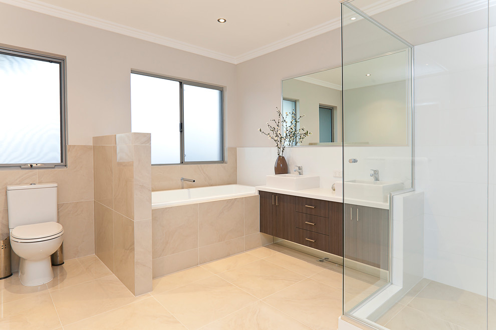 Inspiration for a large modern family bathroom in Perth with brown cabinets, a japanese bath, a double shower, a two-piece toilet, beige tiles, porcelain tiles, beige walls, porcelain flooring, a vessel sink and engineered stone worktops.
