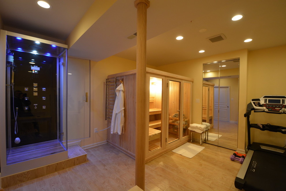 Large modern sauna bathroom in Baltimore with glass-front cabinets, a corner shower, black tiles, yellow walls and light hardwood flooring.