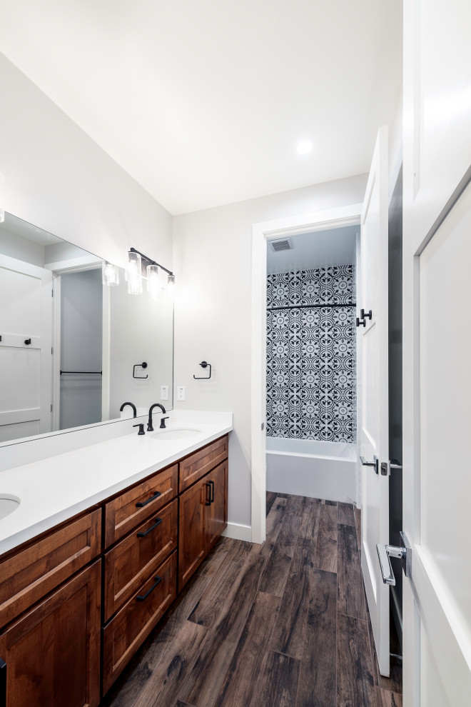 Photo of a small traditional shower room bathroom in San Francisco with shaker cabinets, brown cabinets, a freestanding bath, an alcove shower, multi-coloured tiles, grey walls, porcelain flooring, a submerged sink, solid surface worktops, brown floors and white worktops.