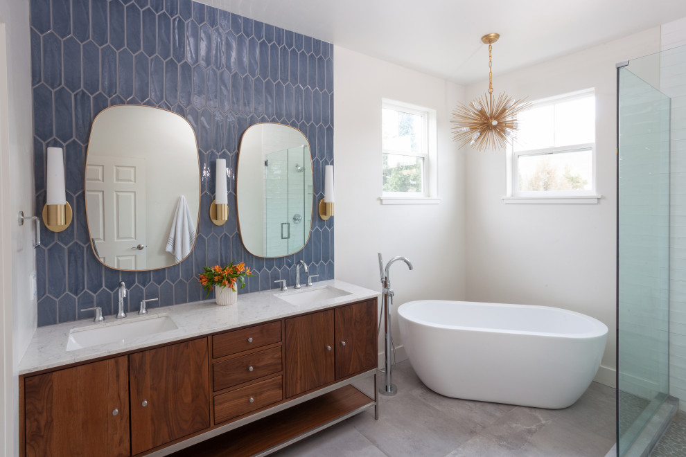 Inspiration for a contemporary blue tile gray floor and double-sink freestanding bathtub remodel in Other with flat-panel cabinets, medium tone wood cabinets, white walls, an undermount sink, gray countertops and a freestanding vanity