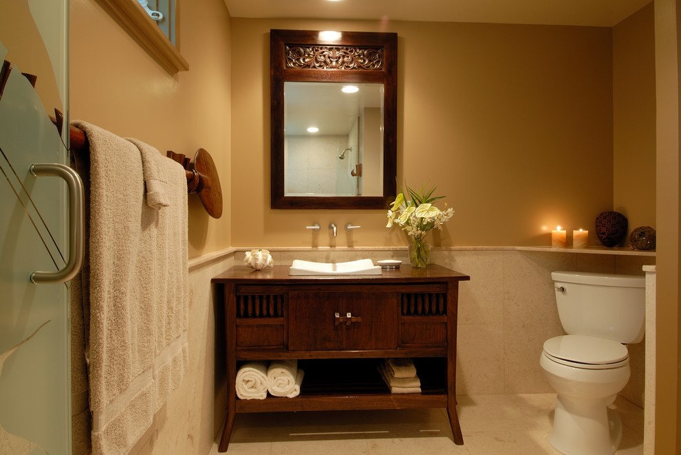 Bild på ett tropiskt badrum, med ett fristående handfat, beige väggar, klinkergolv i porslin och släta luckor