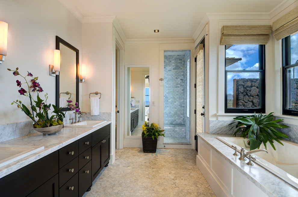 This is an example of a large modern ensuite bathroom in Hawaii with shaker cabinets, dark wood cabinets, a built-in bath, an alcove shower, a two-piece toilet, grey tiles, white tiles, stone slabs, white walls, mosaic tile flooring, a built-in sink, marble worktops, grey floors and an open shower.