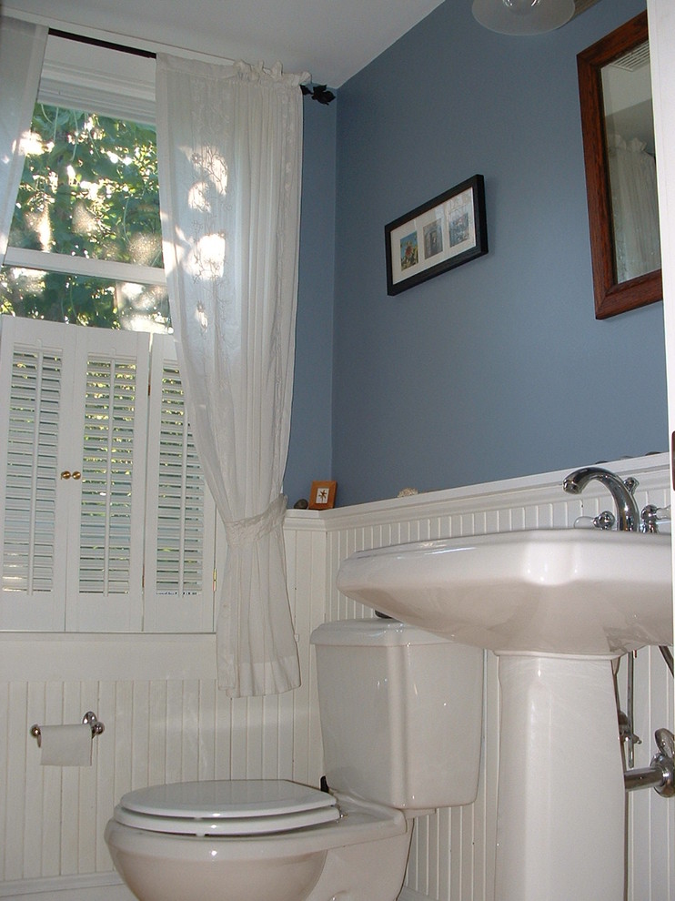Small country shower room bathroom in Boston with white cabinets, a two-piece toilet, blue walls and a pedestal sink.