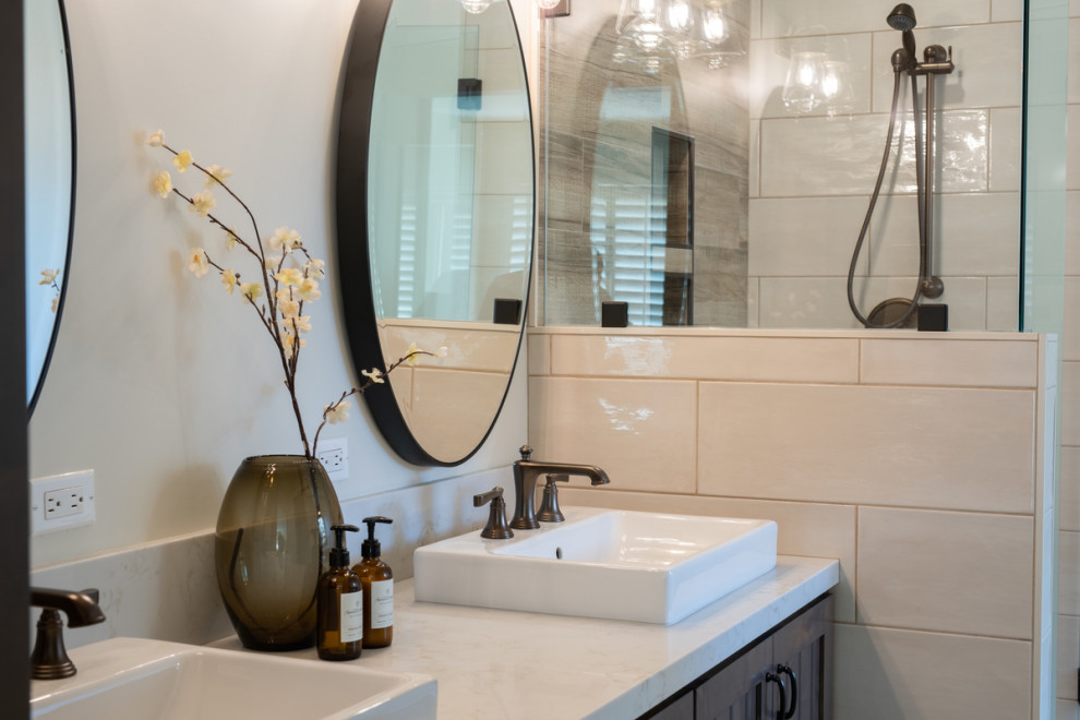 Large country master beige tile and ceramic tile ceramic tile, white floor and double-sink bathroom photo in Other with shaker cabinets, brown cabinets, a two-piece toilet, beige walls, a vessel sink, quartz countertops, a hinged shower door, white countertops and a built-in vanity