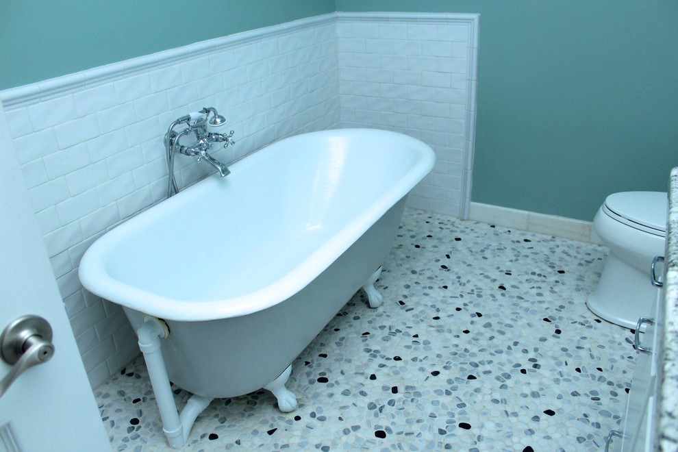 This is an example of a bohemian bathroom in Portland with a submerged sink, shaker cabinets, white cabinets, granite worktops, a claw-foot bath, white tiles, metro tiles, green walls and pebble tile flooring.