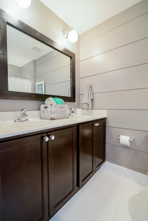 This is an example of a farmhouse bathroom in Baltimore with recessed-panel cabinets, dark wood cabinets, white tiles, ceramic tiles, grey walls and ceramic flooring.