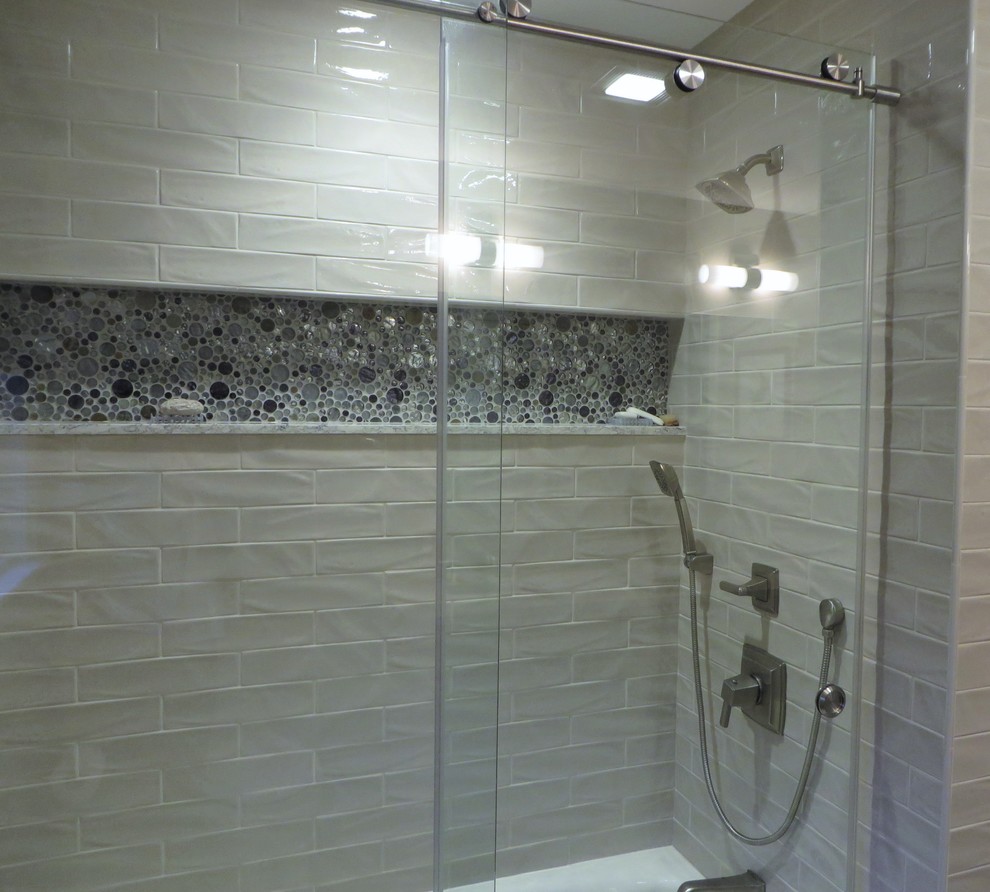 Inspiration for a traditional ensuite bathroom in Boston with an alcove bath, recessed-panel cabinets, white cabinets, a shower/bath combination, a one-piece toilet, green tiles, metro tiles, green walls, porcelain flooring, a submerged sink, engineered stone worktops, beige floors and a sliding door.