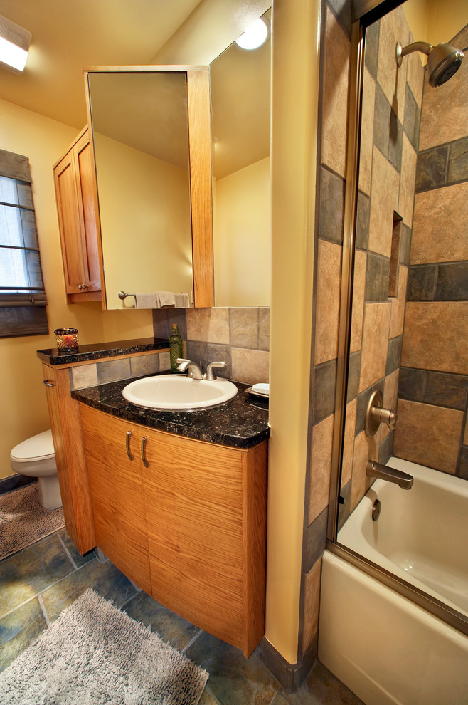 Aménagement d'une petite salle de bain sud-ouest américain en bois brun avec un placard en trompe-l'oeil, un carrelage vert et un plan de toilette en granite.