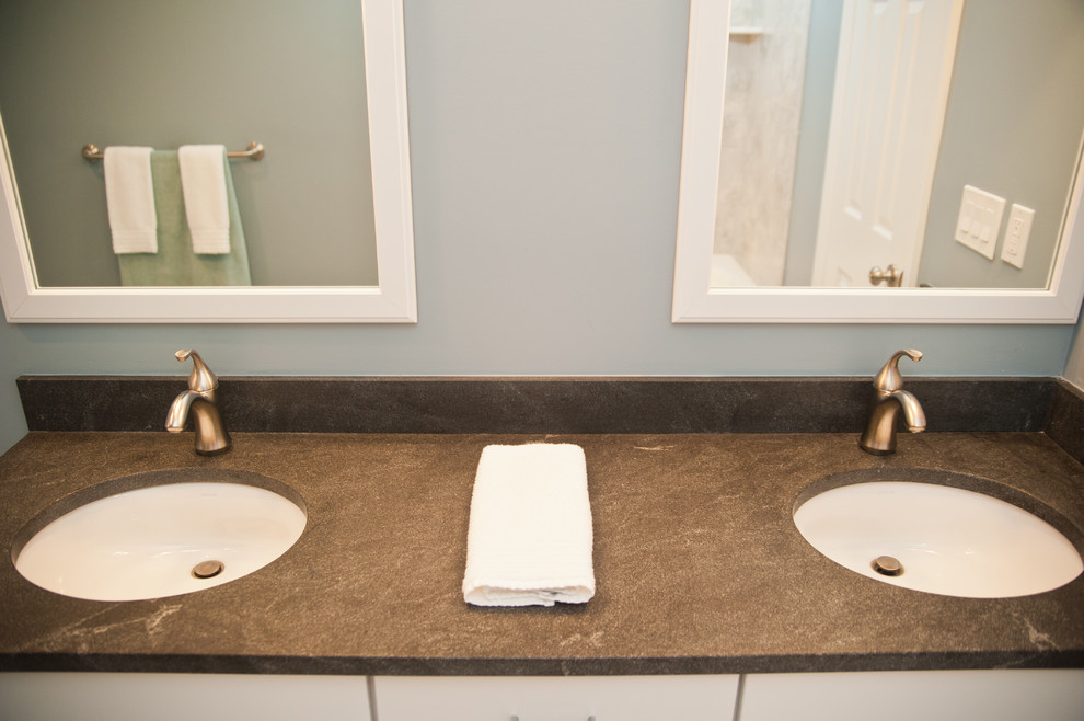 Exemple d'une salle d'eau chic de taille moyenne avec un placard à porte shaker, des portes de placard blanches, WC à poser, un mur bleu, un sol en ardoise, un lavabo encastré et un plan de toilette en stéatite.