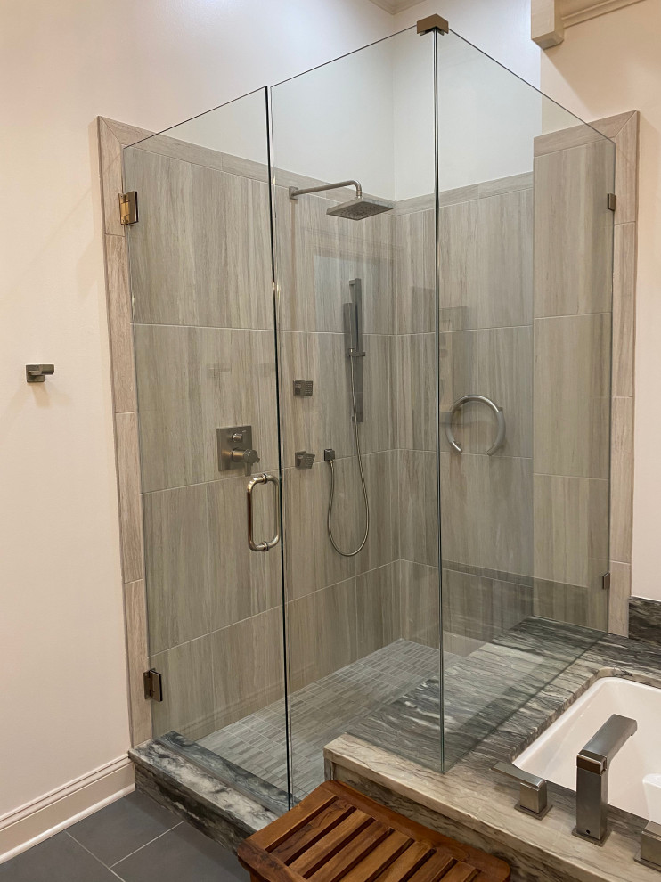 This is an example of a large classic ensuite bathroom in Other with recessed-panel cabinets, light wood cabinets, a submerged bath, an alcove shower, a bidet, grey tiles, porcelain tiles, porcelain flooring, a vessel sink, granite worktops, a hinged door, grey worktops, double sinks and a floating vanity unit.