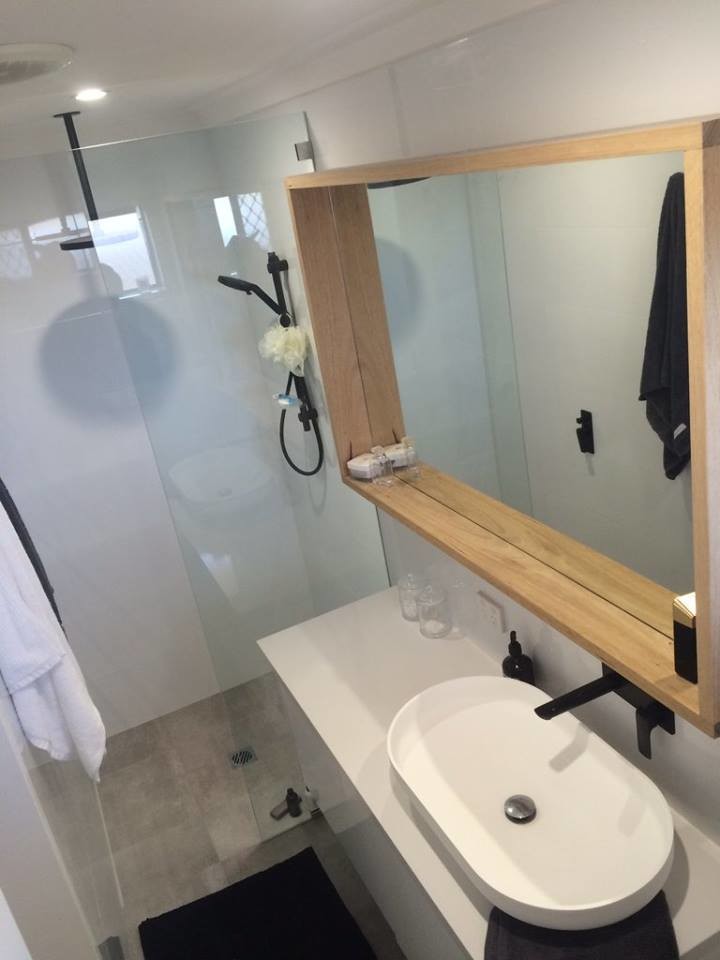 Medium sized contemporary ensuite bathroom in Perth with flat-panel cabinets, white cabinets, a corner shower, white tiles, porcelain tiles, white walls, cement flooring, a vessel sink, solid surface worktops, grey floors and an open shower.