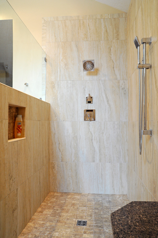 Example of a mid-sized transitional master porcelain tile corner shower design in Other with raised-panel cabinets, dark wood cabinets, beige walls, an undermount sink and granite countertops