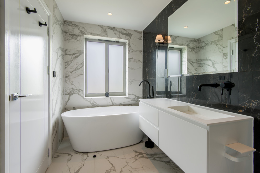 This is an example of a contemporary bathroom in London with tiled worktops.
