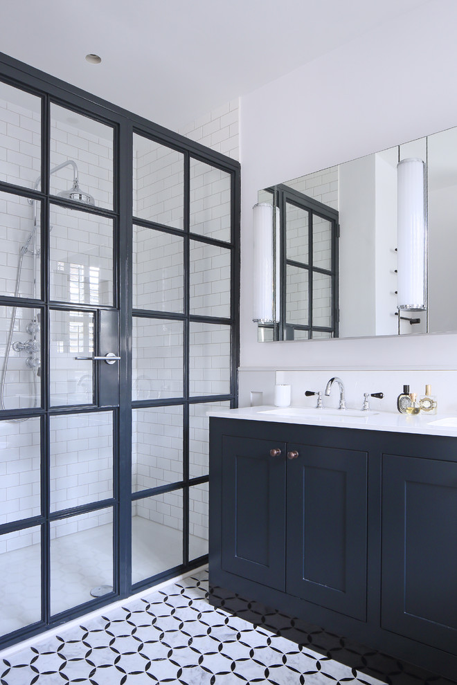 Doorless shower - mid-sized scandinavian 3/4 white tile and subway tile linoleum floor doorless shower idea in London with shaker cabinets, blue cabinets, white walls, an undermount sink and a hinged shower door