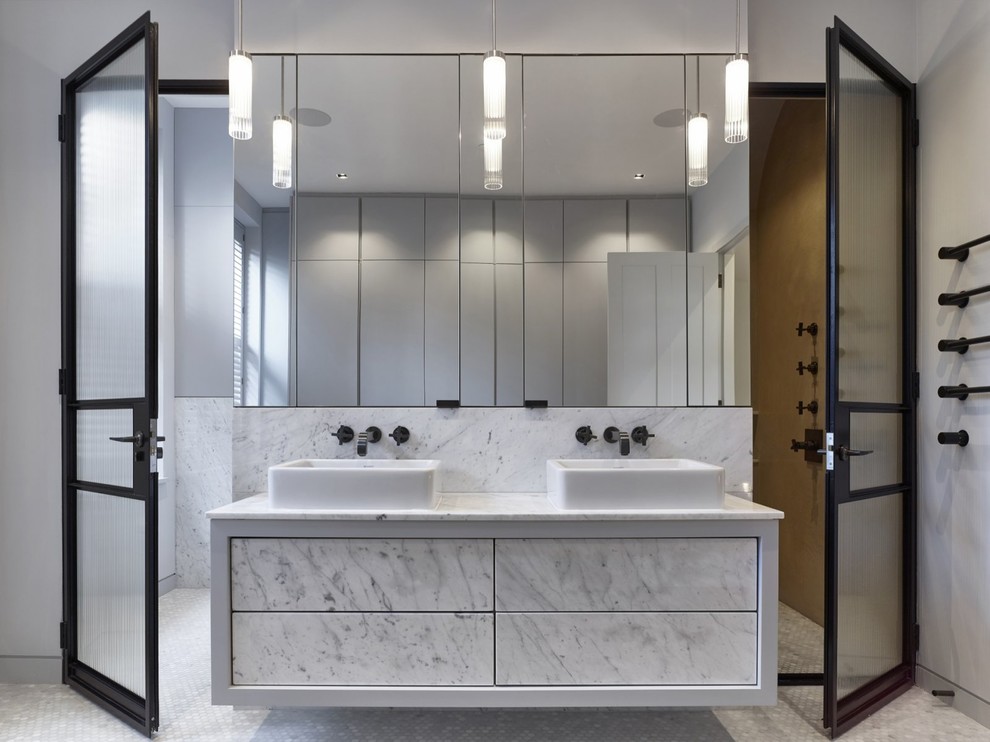 Design ideas for a large contemporary bathroom in Buckinghamshire with flat-panel cabinets, grey cabinets, marble tiles, grey walls, pebble tile flooring, a vessel sink, grey floors and a hinged door.