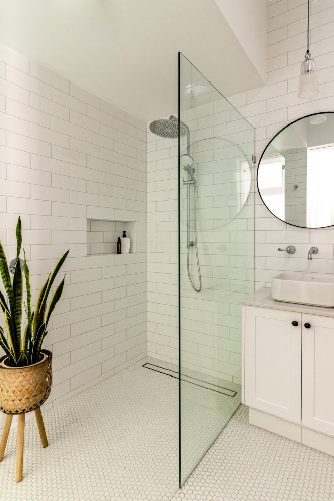 Traditional ensuite bathroom in Perth with shaker cabinets, white cabinets, a walk-in shower, a one-piece toilet, white tiles, metro tiles, white walls, mosaic tile flooring, a vessel sink, engineered stone worktops, white floors, an open shower, grey worktops, a wall niche, double sinks and a built in vanity unit.