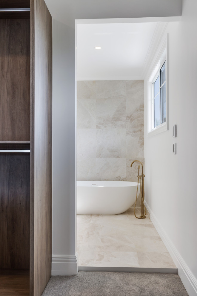 Design ideas for a large coastal ensuite bathroom in Brisbane with shaker cabinets, white cabinets, a freestanding bath, a double shower, a wall mounted toilet, beige tiles, marble tiles, beige walls, marble flooring, a submerged sink, marble worktops, beige floors, an open shower, yellow worktops, double sinks and a built in vanity unit.