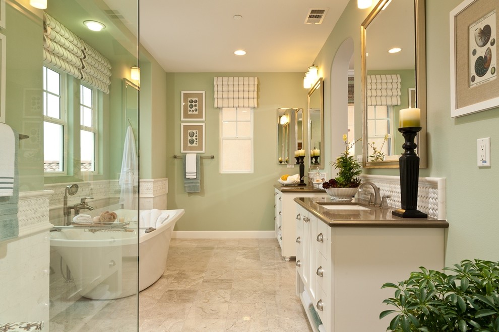 Large elegant master marble floor and beige floor bathroom photo in San Diego with shaker cabinets, white cabinets, green walls, solid surface countertops, an undermount sink and a hinged shower door