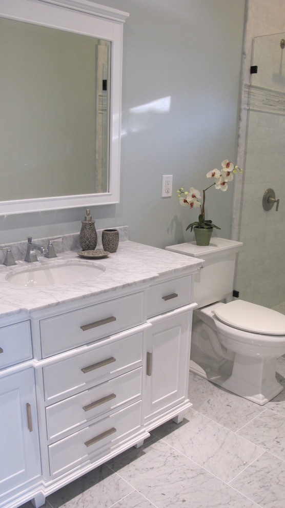 Large nautical family bathroom in New York with a submerged sink, beaded cabinets, white cabinets, marble worktops, a walk-in shower, a two-piece toilet, white tiles, stone tiles, green walls and marble flooring.